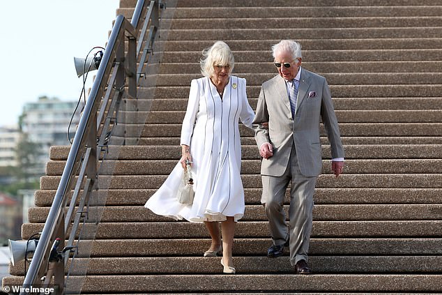 Queen Camilla and King Charles are seen descending the steps of the Sydney Opera House