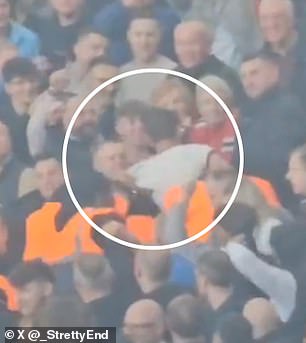 The Man United fan (circled in white top) was hassled by security before being sent away