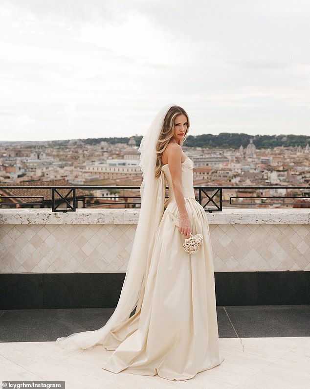 Lucy looked heavenly on her special day in a champagne-colored dress by designer Paula Nadal with a structured bodice that flowed into a voluminous floor-length skirt