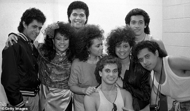 Singers and musicians Eugene (seated front) poses with other members of The Jets after a 1986 concert in Chicago