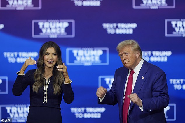 Donald Trump sways to the music at a town hall with Governor Kristi Noem