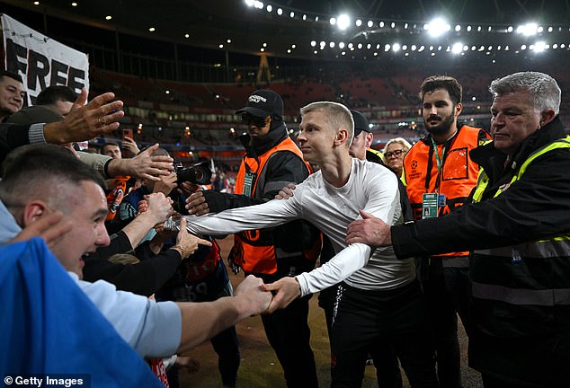 Zinchenko handed his shirt to a fan in the away match as he greeted his compatriots