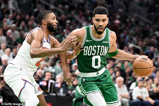 Jayson Tatum of the Boston Celtics rides Knicks forward Mikal Bridges on Tuesday