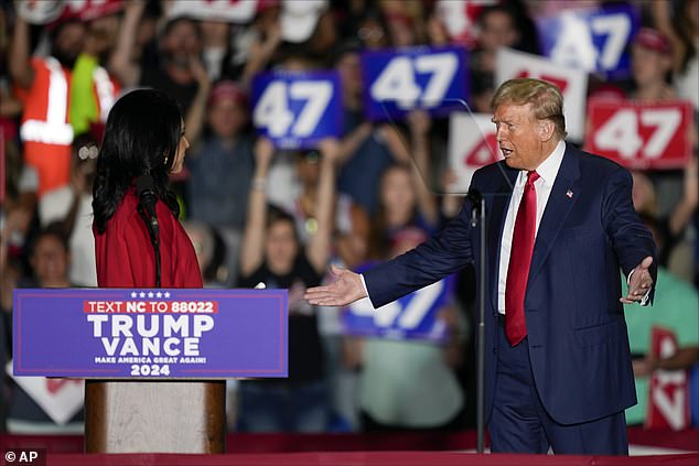 Trump looks on in shock as Gabbard announces her switch to the Republican Party at his rally in North Carolina