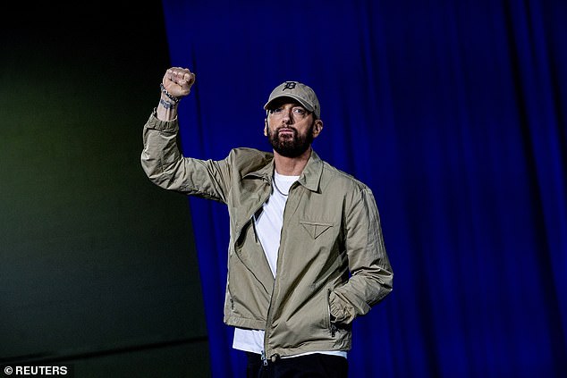 Detroit-based rapper Eminem pumped his first as he walked onstage to introduce former President Barack Obama during a rally Tuesday night in support of Democratic nominee Vice President Kamala Harris