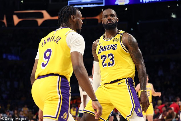 LeBron James stares into the crowd next to his son Bronny during Tuesday's opener