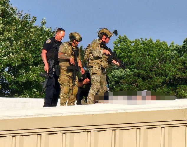 Of particular concern, a building widely believed to pose a security risk was left unsecured, allowing gunman Thomas Matthew Crooks, 20, to gain access to it. The photo shows Secret Service agents standing near the would-be killer's body after the shooting