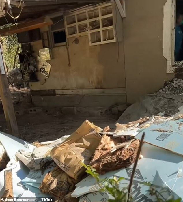 The house in North Carolina was completely destroyed after floodwaters reached the roof and the homeowner had to be rescued from his roof by people on rafts