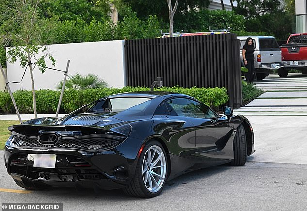 Beckham is spotted arriving to inspect his newly purchased home in a McLaren supercar