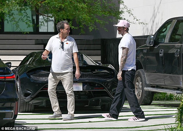 Beckham appears relaxed as he walks into the home with 100 feet of facade on Biscayne Bay