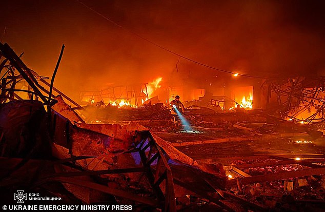 A rescue worker searches for survivors in the aftermath of a Russian attack in Mykolaiv, Ukraine