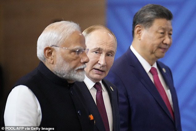 Indian Prime Minister Narendra Modi, Russian President Vladimir Putin and Chinese President Xi Jinping attend a family photo during the BRICS Summit in Kazan on October 23, 2024