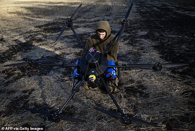 A Ukrainian soldier from the 30th Separate Mechanized Brigade prepares to conduct test flights of a hexacopter drone ahead of the combat mission in the eastern Donetsk region on October 22, 2024