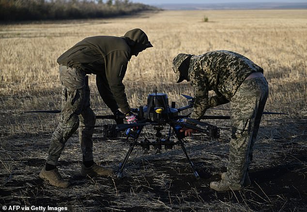 Ukrainian soldiers of the 30th Separate Mechanized Brigade prepare to conduct test flights of a hexacopter drone ahead of the combat mission in the eastern Donetsk region on October 22, 2024