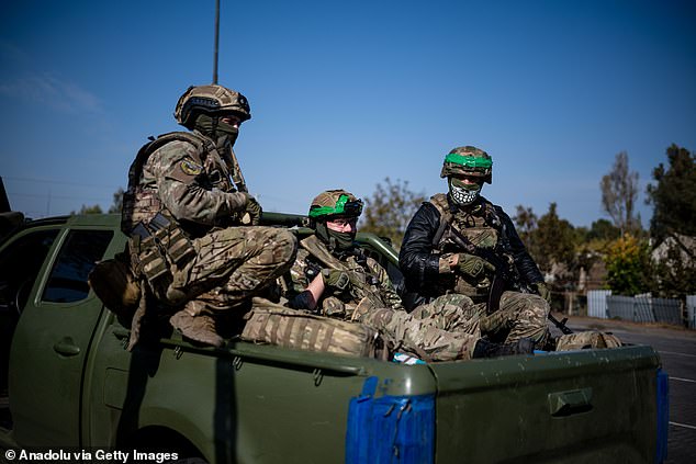 Ukrainian soldiers of the Liut Brigade sit in a pickup truck on their way back to the frontline town near Khasiv Yar in the Donetsk region, Ukraine on October 7, 2024