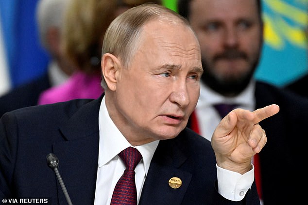 Russian President Vladimir Putin points during the expanded meeting of the BRICS Summit in Kazan, Russia on October 23