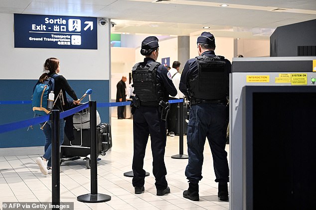 Police stand at a customs checkpoint at Roissy-Charles de Gaulle Airport, in the northern suburbs of Paris, on October 18, 2024