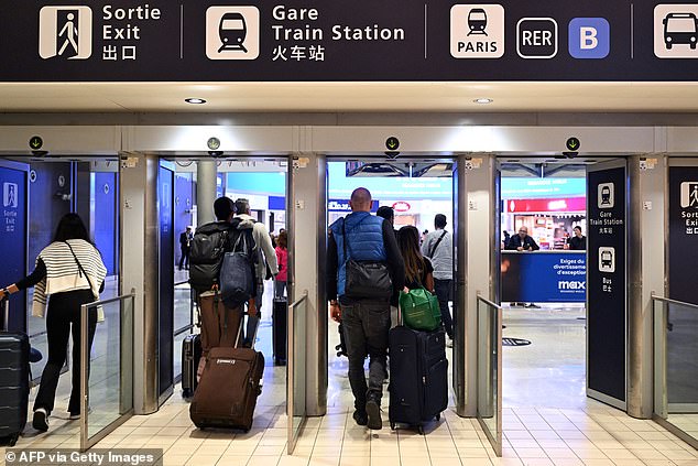 Passengers passing through an exit at Roissy-Charles de Gaulle Airport