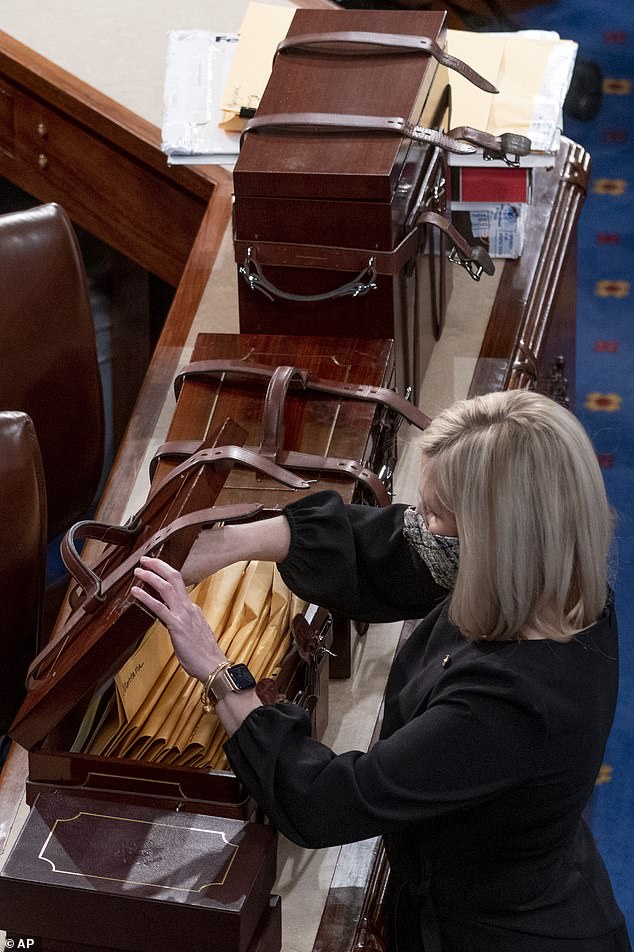 Boxes containing the Electoral College votes from the 2020 elections are opened during a joint session of the House and Senate on January 6, 2021