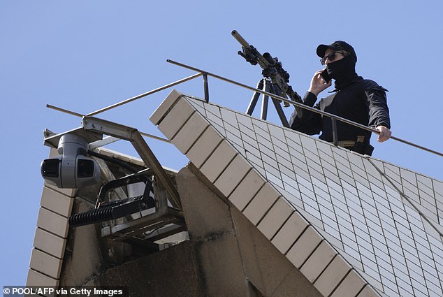 The snipers were dressed in black, with a scarf covering half their faces. They also wore black caps and sunglasses.