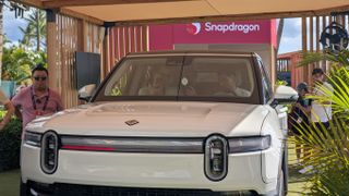 Rivian R1S truck under a Snapdragon logo