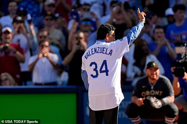 Valenzuela waves to the crowd before throwing out a ceremonial first pitch at Dodger Stadium