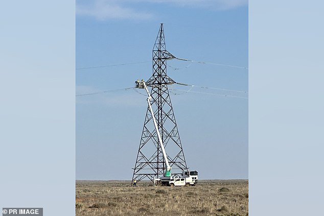 Workers repair the electrical grid after storms wiped out power lines. (Provided by Transgrid/AAP PHOTOS)