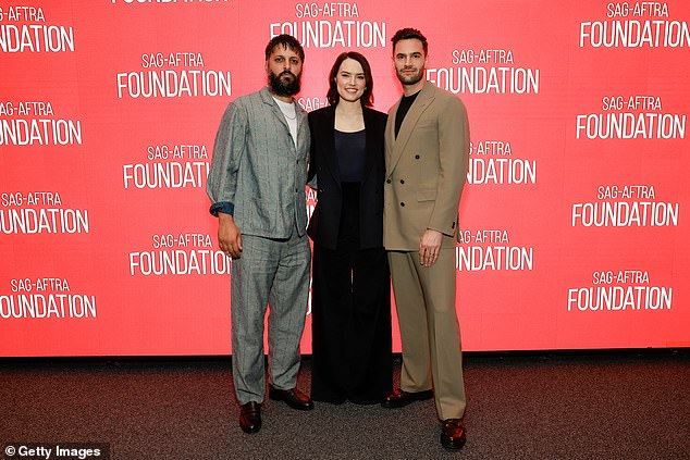 At one point she posed next to Shazad Latif and husband Tom Bateman (right), who wrote the screenplay for the film