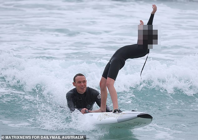 The Bondi Rescue star, known as 'Reidy', put on a brave face as he was spotted paddle boarding with a friend and two children in North Bondi