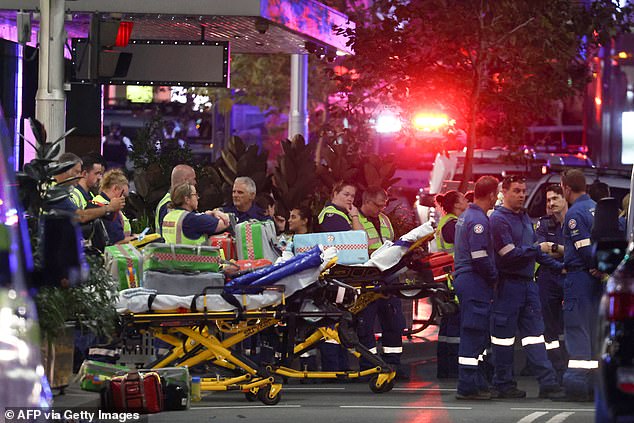 Paramedics are seen with stretchers outside the Westfield Bondi Junction shopping center following a stabbing incident in Sydney on April 13, 2024