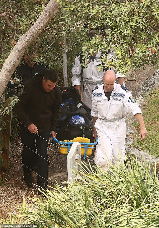 Emergency services recover Thijssen's body after it was seen wedged in rocks under a clifftop park, two days after he killed Mrs James