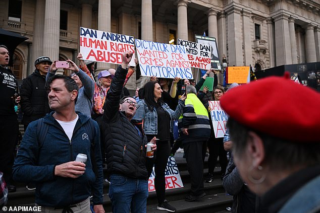 People gather on the steps of Victoria's Parliament House to celebrate Andrews stepping down as prime minister last year