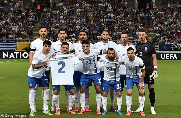 The Greek players pose for a team photo ahead of the match against Ireland, displaying the shirt of the late George Baldock after his death at the age of 31