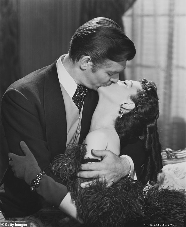 Today, kissing has a multitude of uses, including as a sign of romantic and sexual attraction, often depicted in films. Pictured: Rhett Butler (Clark Gable) and Scarlett O'Hara (Vivien Leigh) in 'Gone with the Wind' (1939)