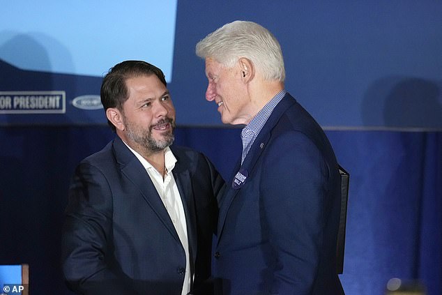 Former President Bill Clinton, right, speaks briefly with Arizona Democratic Senate candidate Ruben Gallego as Clinton takes the stage during a campaign event in support of Democratic presidential candidate Vice President Kamala Harris