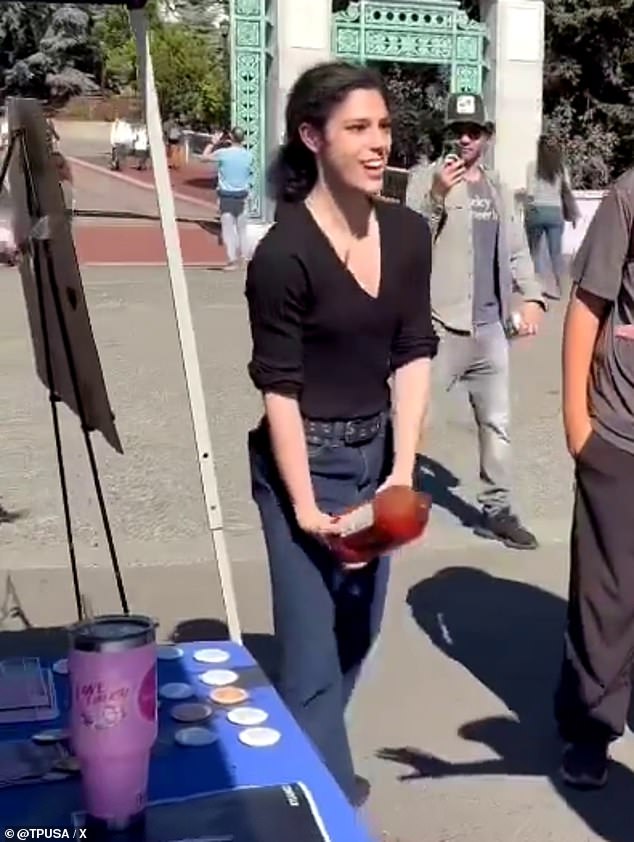 You can see the person pouring the juice over the plates and the table, which is covered in badges and posters