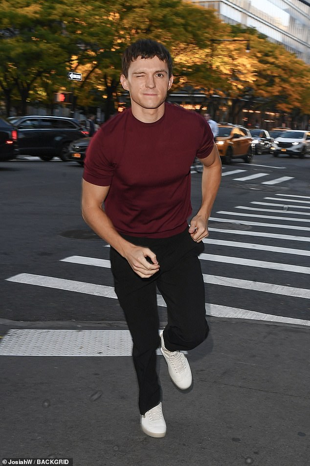 He winked and looked dashing in a maroon shirt and black pants