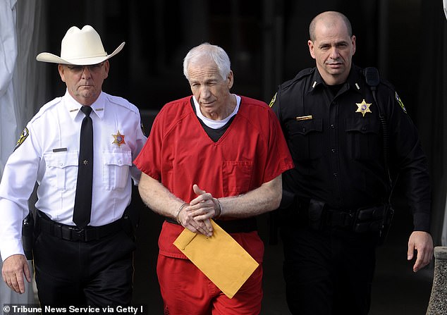 Jerry Sandusky, center, is escorted from his sentencing hearing at the Center County Courthouse in Bellefonte on Tuesday, October 9, 2012