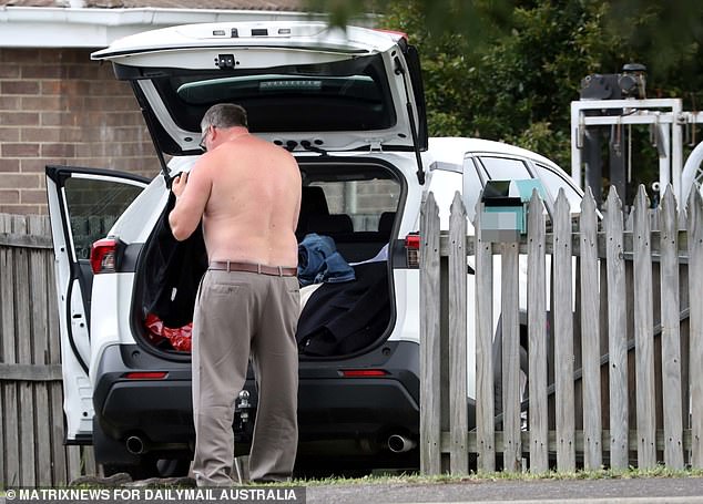 Hallam steps out of his courtroom into the front yard of a fisherman friend's house