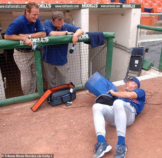 Dodgers pitching coach Jim Colborn, right, playfully disrupts a recording of Fox Sports Network announcers Steve Lyons, left, and Charley Steiner in 2005, Steiner's first year with the club