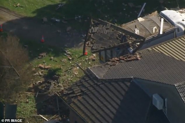 The truck destroyed the front of the house, leaving part of the timber frame dangling from the rear of the vehicle