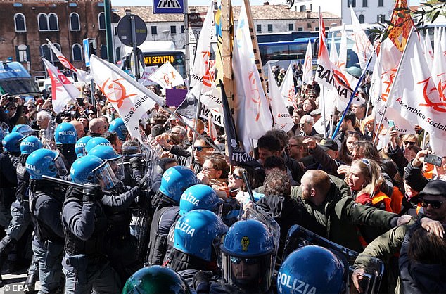 Members of social centers confront police officers during a demonstration in Piazzale Roma against the introduction of an entrance fee for day trippers in the city, in Venice, April 25