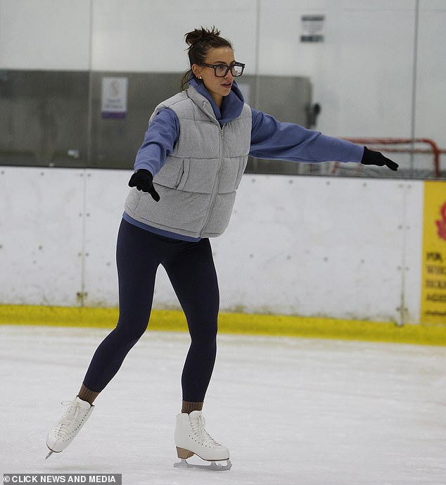 Ferne wrapped herself against the cold in a puffed gray sleeveless jacket