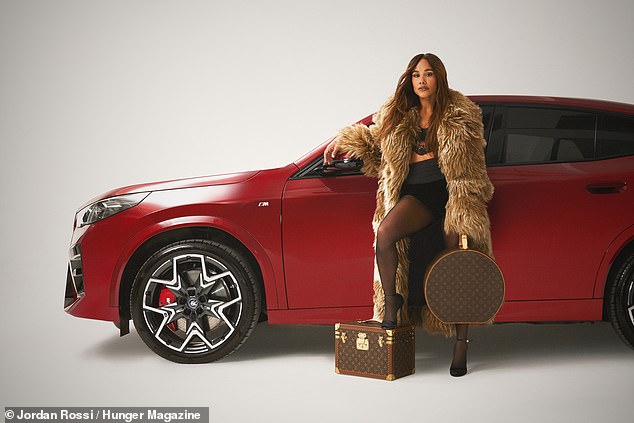 The footballer turned broadcaster put on a racy performance in a black underwear set and tights as she posed next to Louis Vuitton luggage in a brown fur coat