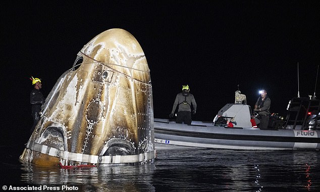 This photo from NASA shows support teams working around the SpaceX spacecraft shortly after it landed, in the Gulf of Mexico off the coast of Pensacola, Florida, Friday, October 25, 2024