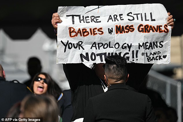 A woman (left) interrupted President Joe Biden and shouted “liberate Palestine,” while another protester held up a sign that read “there are still babies in mass graves.” Your apology means nothing.”