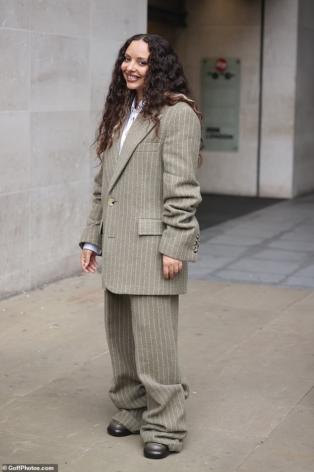 After Jade's performance, she left the BBC studios in an oversized gray-green pinstripe suit that she paired with platform heels.