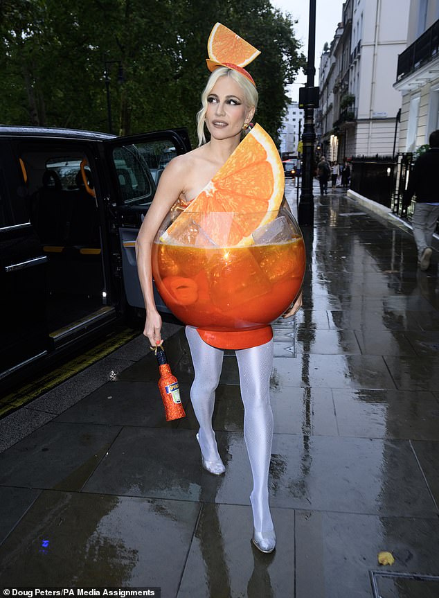 The singer turned heads when she was spotted arriving at the exclusive Mayfair Members Club Annabel's dressed as the iconic Aperol Spritz cocktail