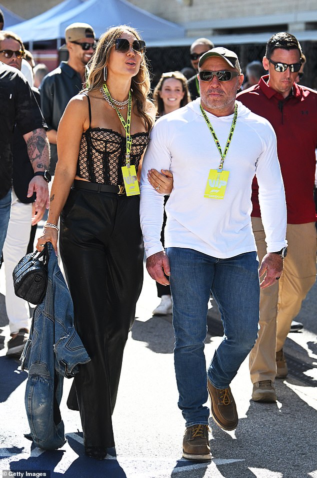 Jessica Ditzel and Joe Rogan walk in the Paddock prior to the F1 United States Grand Prix at Circuit of The Americas on October 20, 2024 in Austin, Texas