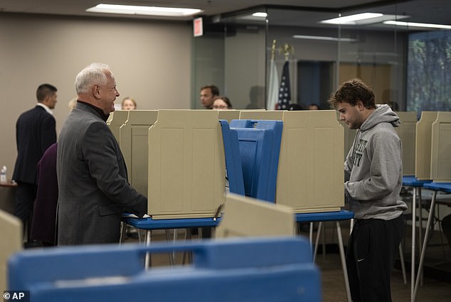 First-time voters Tim Walz and his son Gus cast their ballots on Wednesday